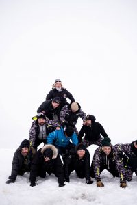Chefs and ice fishermen form a human pyramid after ice fishing on Lake Winnipeg