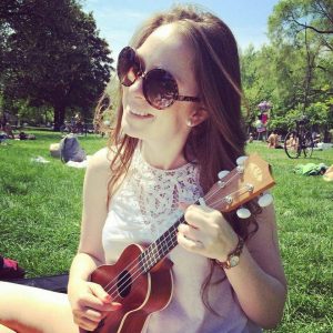 Aimee Cook plays a ukelele in Trinity Bellwoods Park