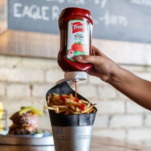 French's Ketchup squeezed onto fries at Smoque N Bones, Toronto