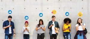 Generation z browsing social media on their smartphones with emojis