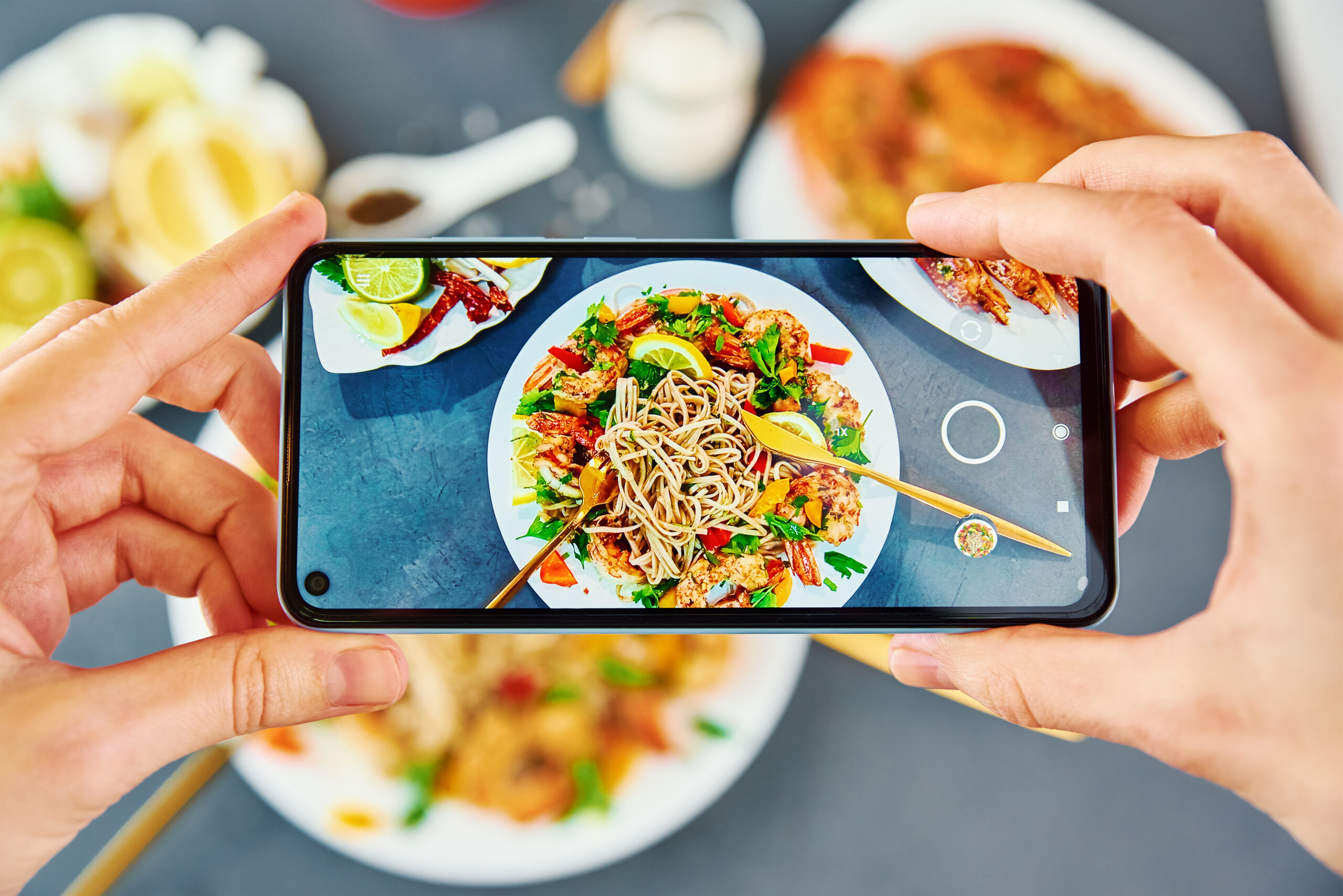 Taking a photo of stir fry noodles with a smartphone
